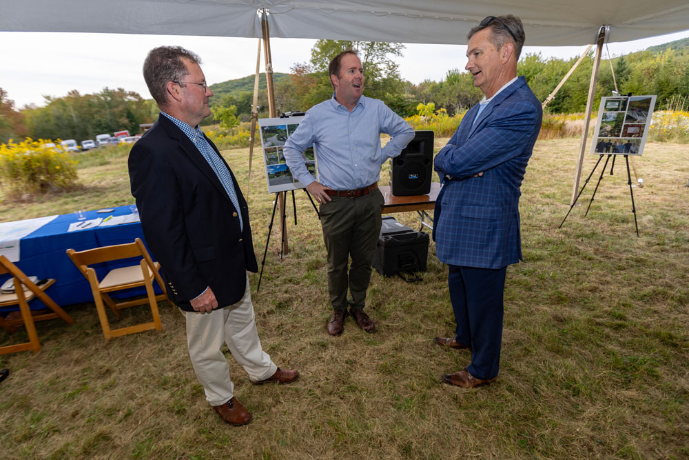 Maine Water President Mark Vannoy, Coastl Mountains Land Trust Executive Director Ian Stewart and SJW Group Chair, CEO, and President, Eric W. Thornburg talk during an event to celebrate the ongoing partnership to protect open space and water resources Wednesday, Sept. 18, 2024.